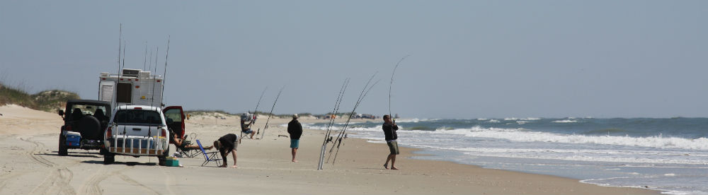 Beach driving safety equipment including emergency flag, first aid kit, and recovery gear laid out for permit preparation