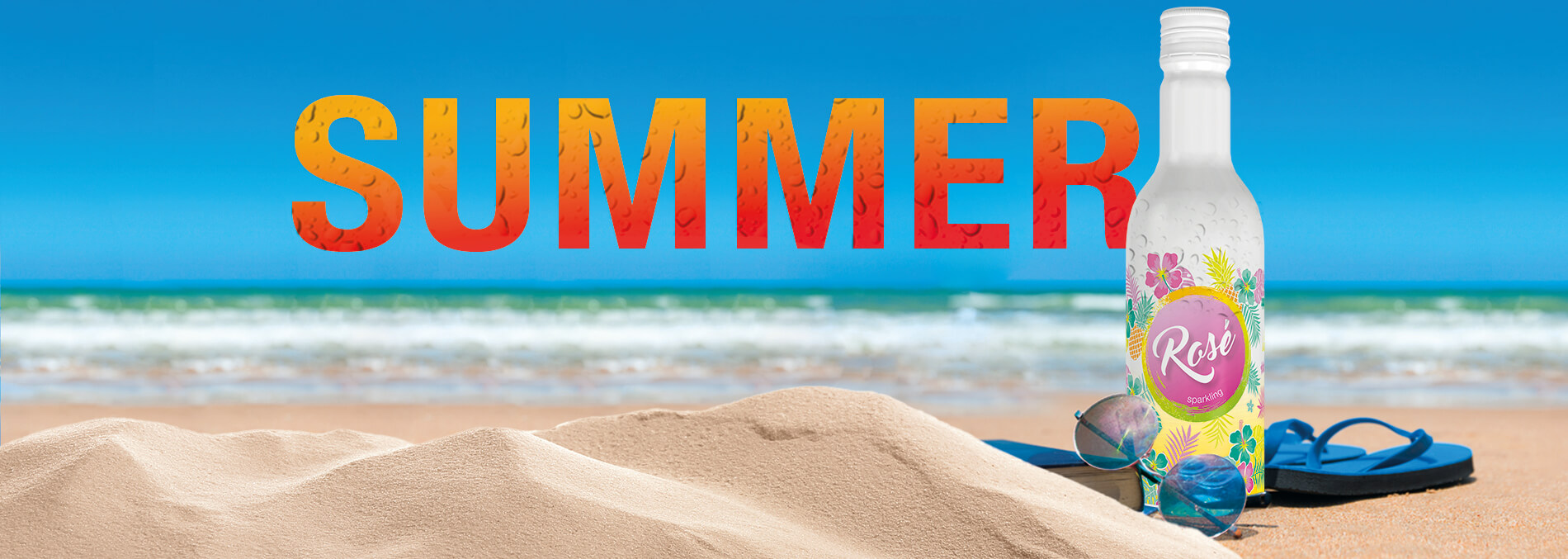 bottle of chilled rosé on beach