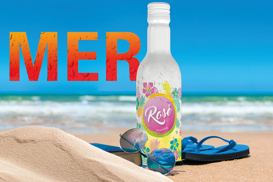 bottle of chilled rosΓ© on beach