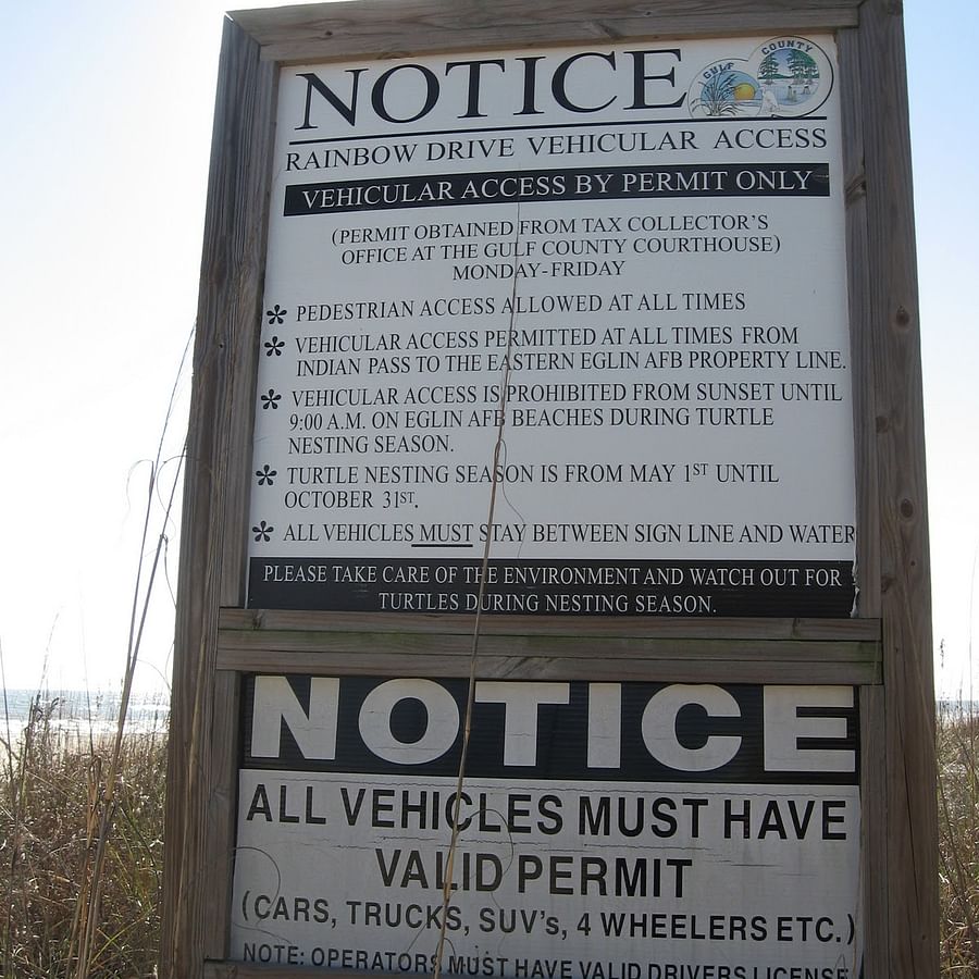 Signboard displaying beach driving permit rules in Florida