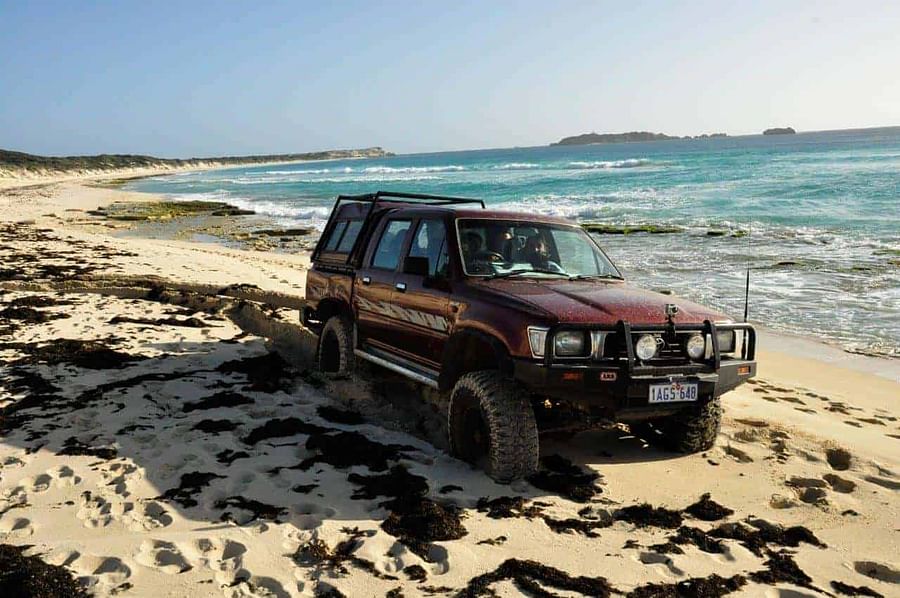 Car tires with varying pressure levels on a sandy beach